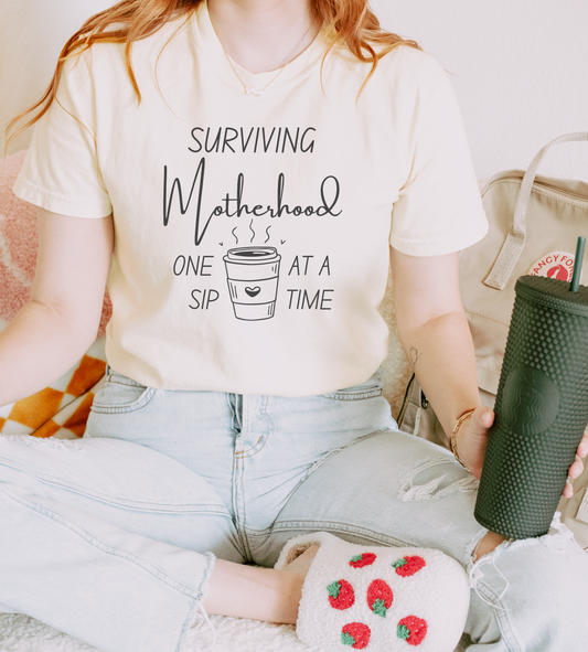Surviving Motherhood One Sip at a Time Tee