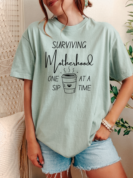 Surviving Motherhood One Sip at a Time Tee